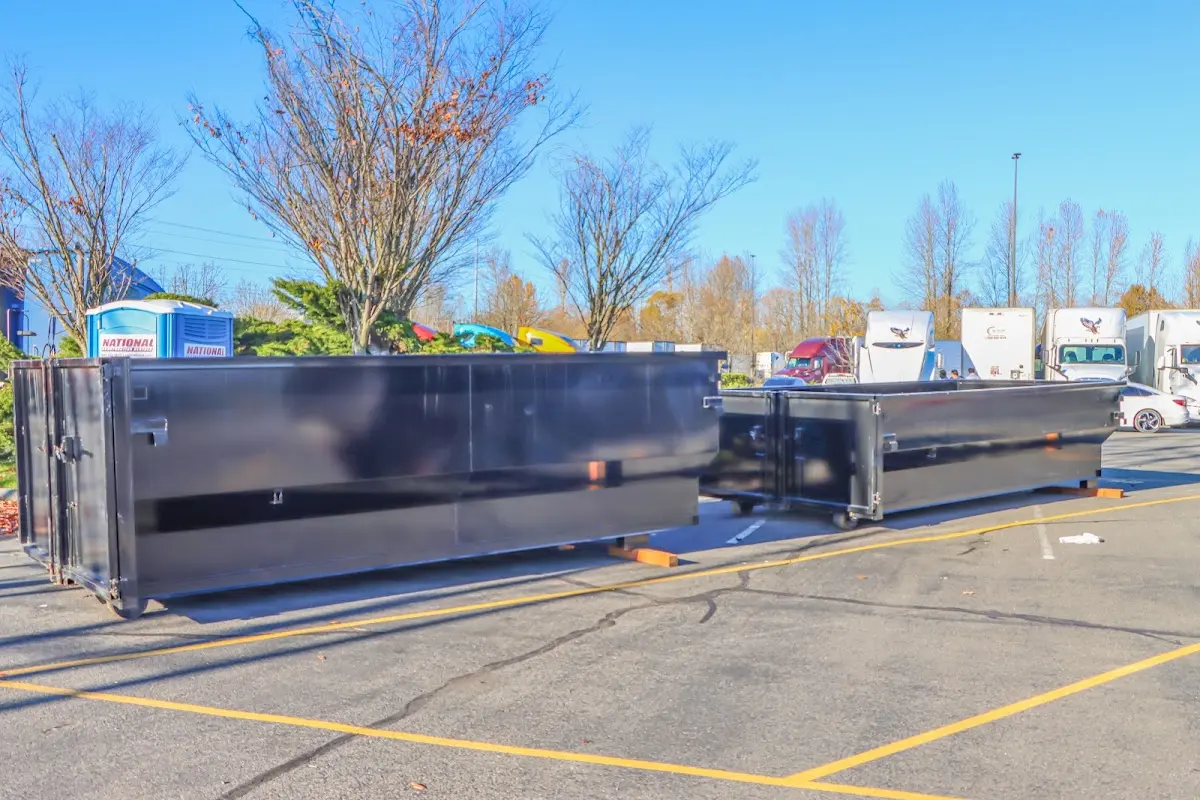 Professional dumpster rental service with roll-off container on residential driveway in Patchogue